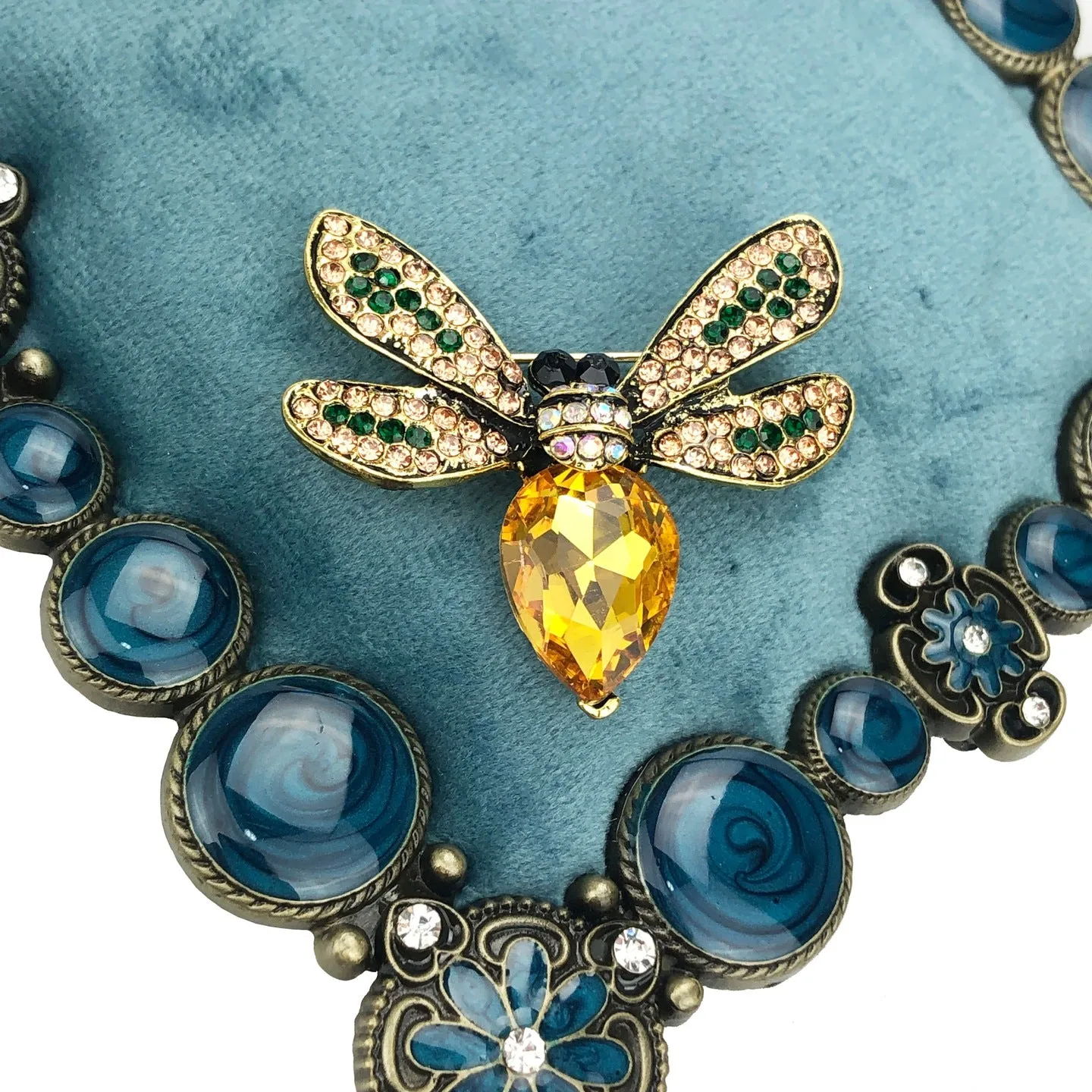 Yellow insect brooch with zircons