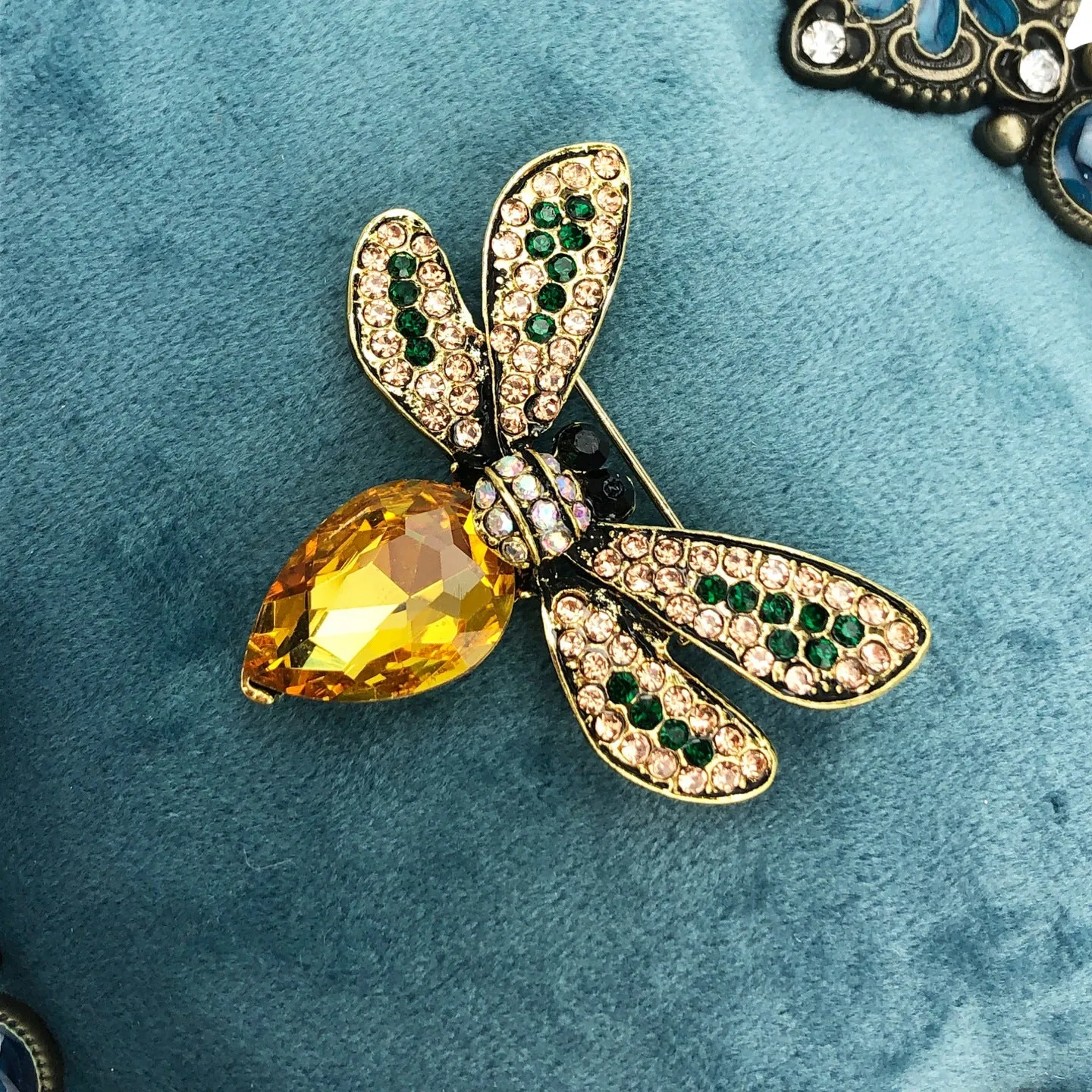 Yellow insect brooch with zircons